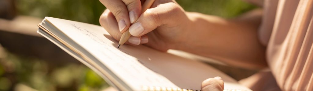 hand-writing-notebook-close-up